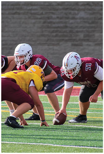 A football game is being played on a field. Description generated by AI