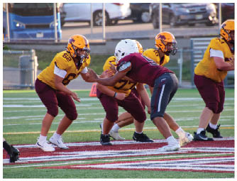 A group of football players on a field. Description generated by AI