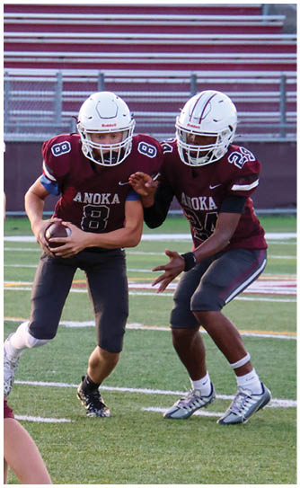A football player catching a ball. Description generated by AI