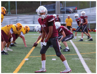 A group of football players on a field. Description generated by AI