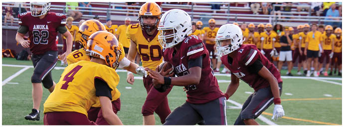 A football player wearing a blue and white uniform. Description generated by AI