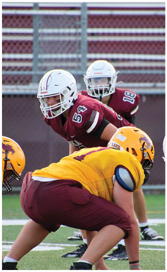 A football player catching a ball. Description generated by AI