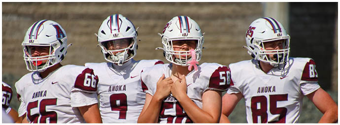 A football player wearing a blue and white uniform. Description generated by AI