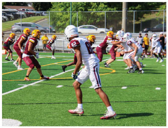 A group of football players on a field. Description generated by AI