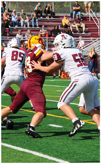 A football player catching a ball. Description generated by AI
