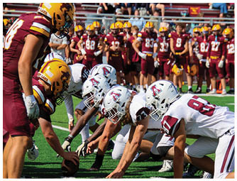 A group of football players on a field. Description generated by AI