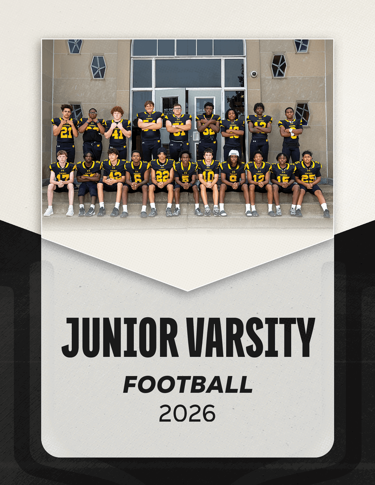 A group of adults wearing black and yellow football uniforms pose in two rows on steps in front of a building with the text Junior Varsity Football 2026 below them. Description generated by AI