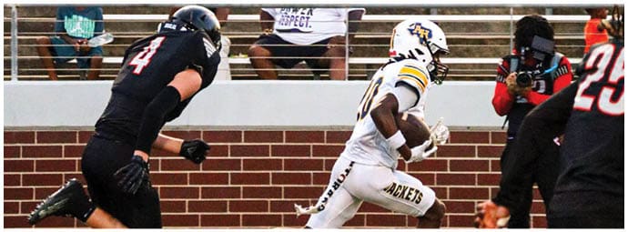 A football player wearing a blue and white uniform. Description generated by AI
