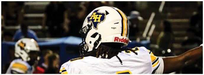 A football player wearing a blue and white uniform. Description generated by AI