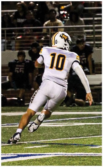 A football player catching a ball. Description generated by AI