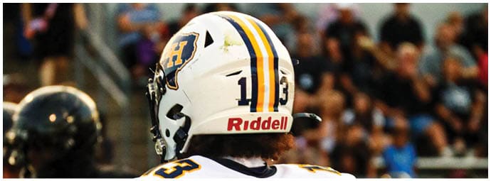 A football player wearing a blue and white uniform. Description generated by AI
