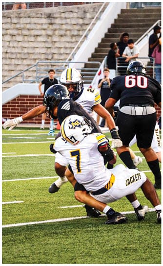 A football player catching a ball. Description generated by AI