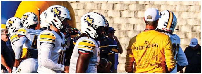 A football player wearing a blue and white uniform. Description generated by AI
