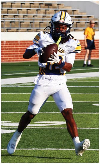 A football player catching a ball. Description generated by AI