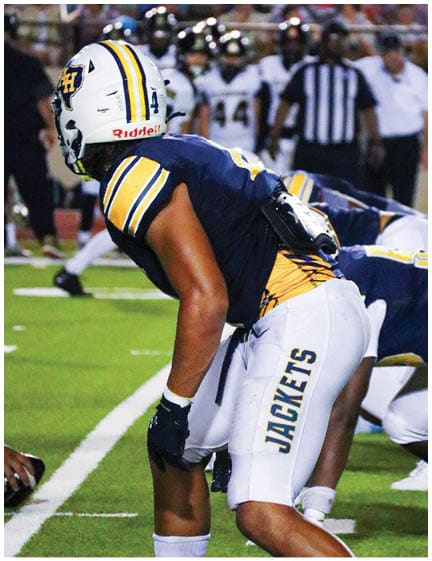 A football player wearing a blue jersey with the number 58 on it. Description generated by AI