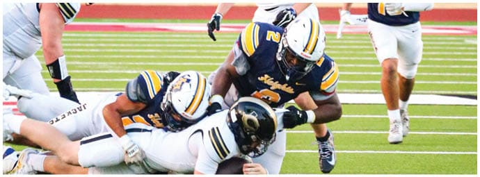 A football player wearing a blue and white uniform. Description generated by AI
