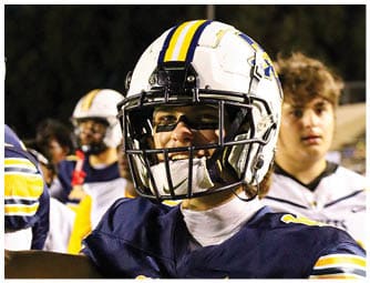 A group of football players on a field. Description generated by AI