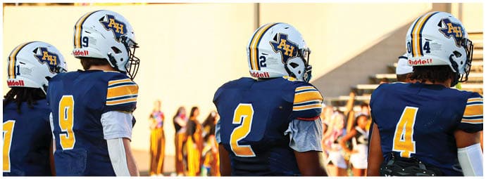 A football player wearing a blue and white uniform. Description generated by AI