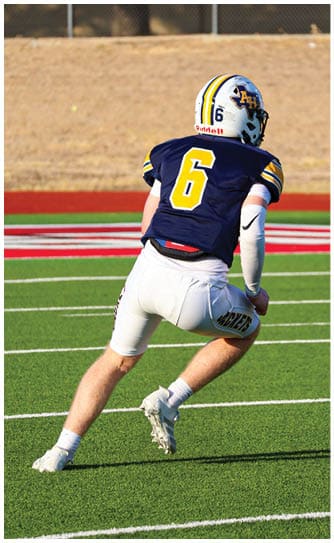 A football player catching a ball. Description generated by AI