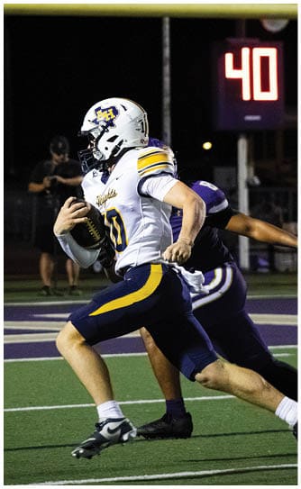 A football player catching a ball. Description generated by AI