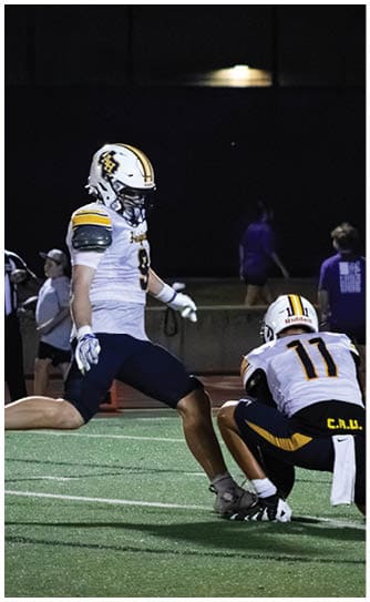 A football player catching a ball. Description generated by AI