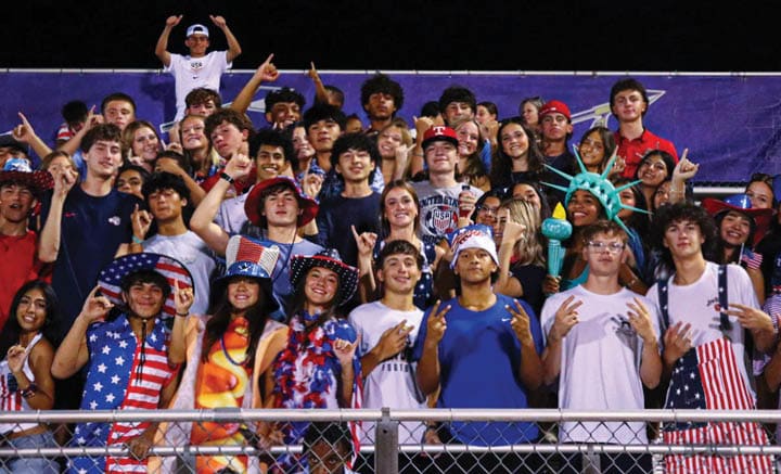 A group of people are kneeling on a field, possibly in a football game. AI generated content