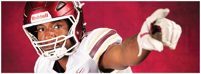 A person wearing a white football uniform with the word “Astronaut" and the number 7 is in an action pose against a red background. Description generated by AI