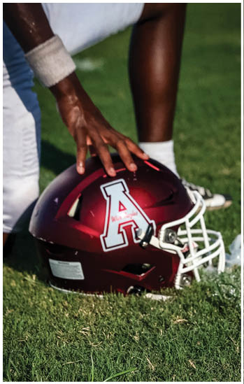 A football player running on the field. Description generated by AI