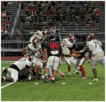 A football player is kicking a football on a field. Description generated by AI