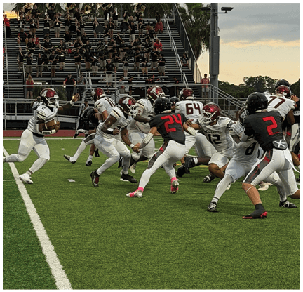 A football player is kicking a football on a field. Description generated by AI