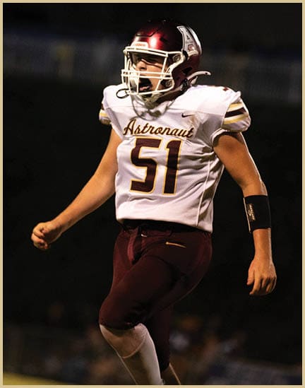 A football player wearing a black jersey with the number 11 on it. Description generated by AI