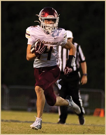 A football player wearing a black jersey with the number 11 on it. Description generated by AI