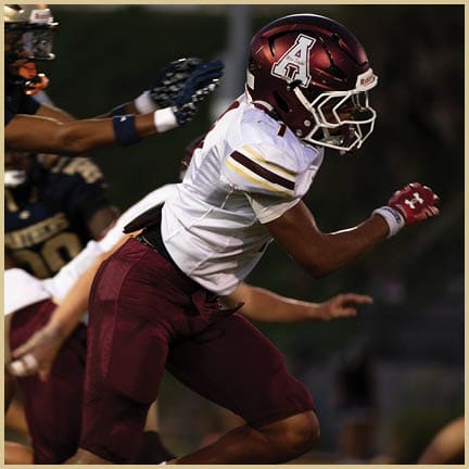 A football player is kicking a football on a field. Description generated by AI
