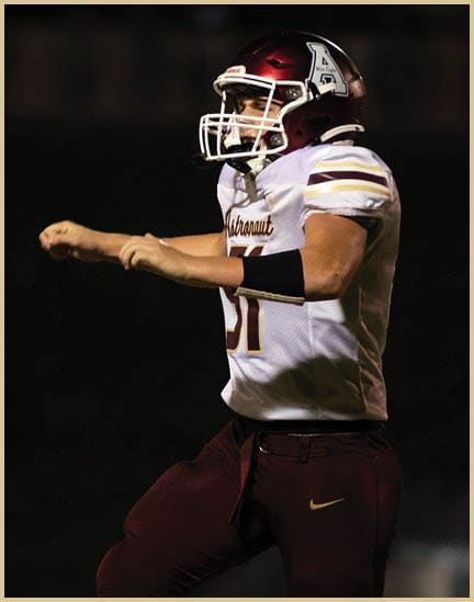 A football player wearing a black jersey with the number 11 on it. Description generated by AI