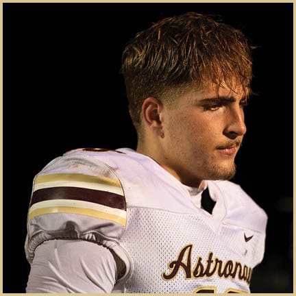 A football player is kicking a football on a field. Description generated by AI