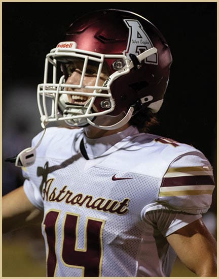 A football player wearing a black jersey with the number 11 on it. Description generated by AI