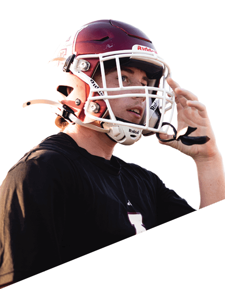 A man catches a football in a field while another man watches. AI generated content