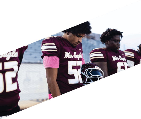 A group of young men wearing black and white uniforms are standing on a field. AI generated content