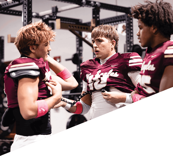 A football player is kneeling on the field, holding his helmet in his hands. AI generated content