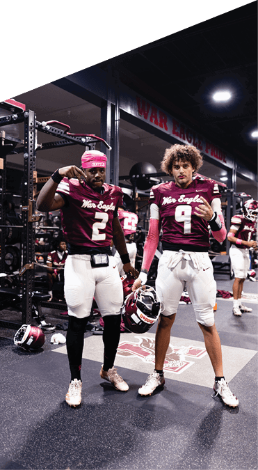 Two young men wearing football uniforms and making hand gestures. AI generated content
