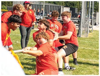 A group of football players on a field. Description generated by AI