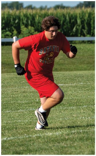 A football player catching a ball. Description generated by AI