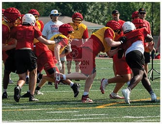 A group of football players on a field. Description generated by AI