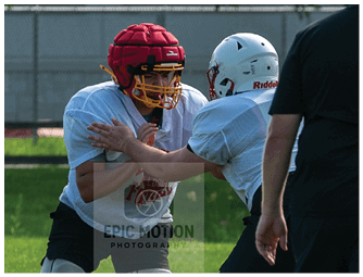 A group of football players on a field. Description generated by AI