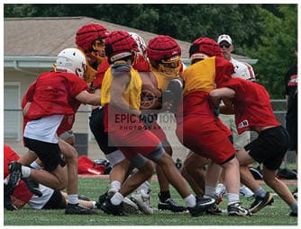 A group of football players on a field. Description generated by AI