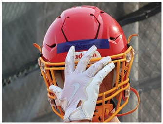 A group of football players on a field. Description generated by AI