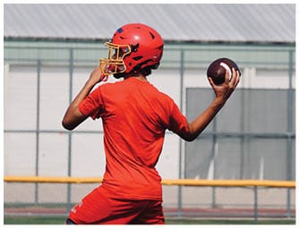 A group of football players on a field. Description generated by AI