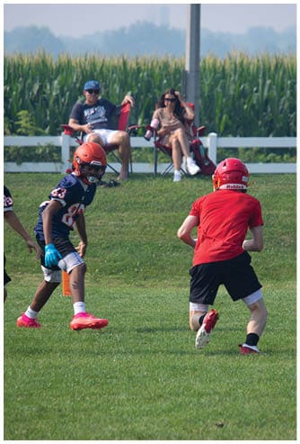 A football game is being played on a field. Description generated by AI