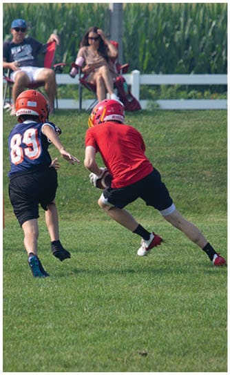 A football player catching a ball. Description generated by AI