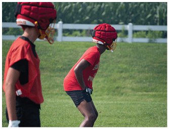 A group of football players on a field. Description generated by AI
